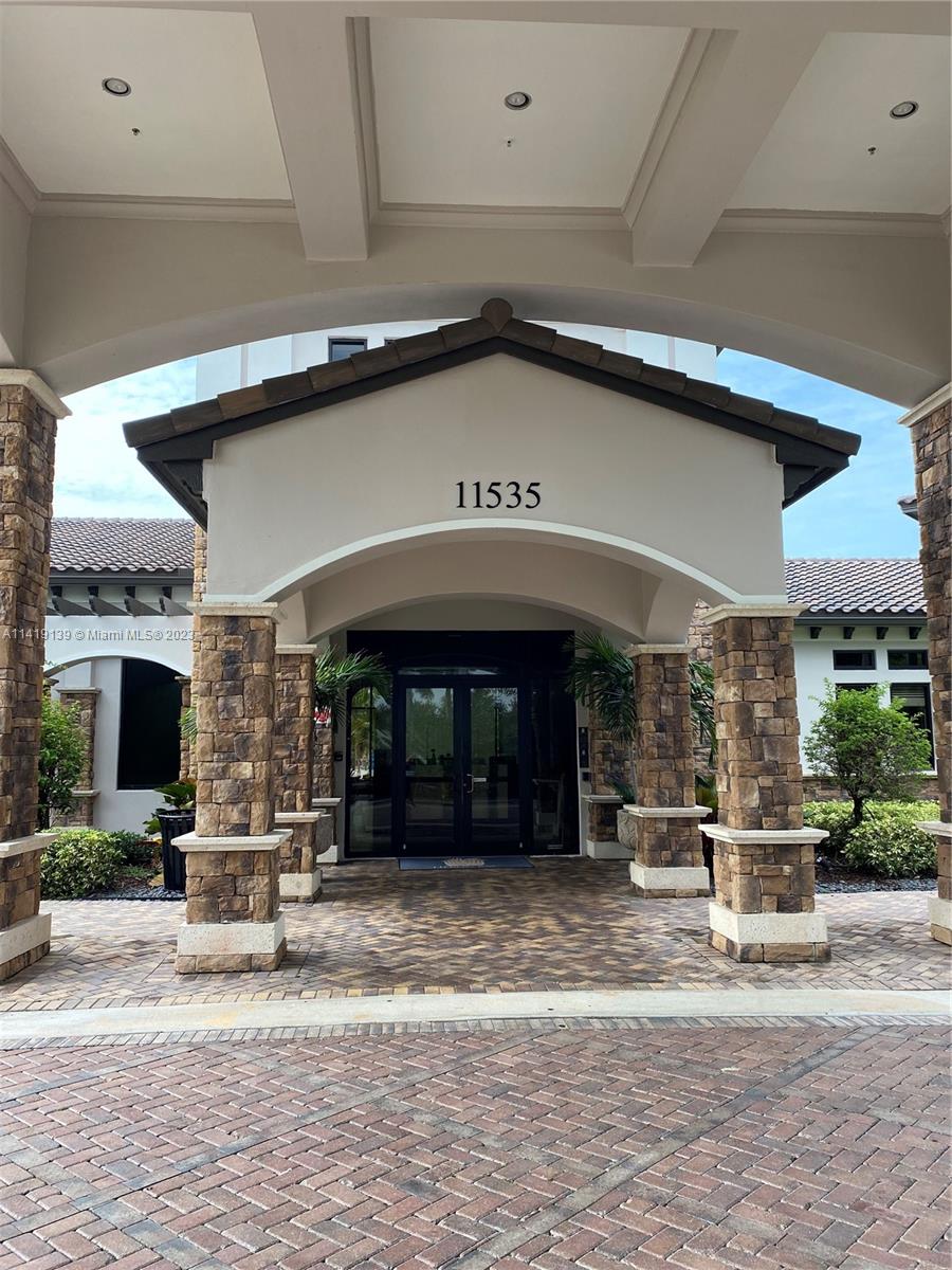 7982 Northwest 109th Lane Parkland, FL 33076 - Photo 52 of 71 a view of a building with a bench in front of building