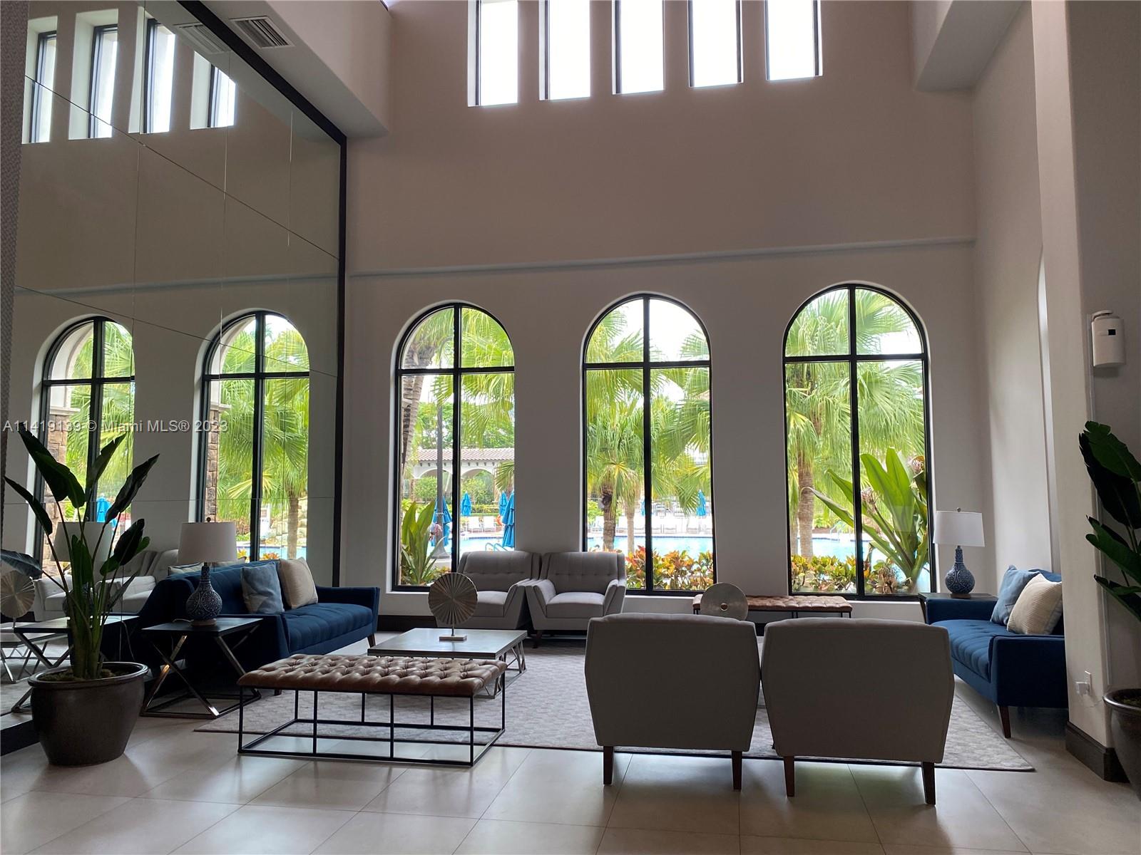 7982 Northwest 109th Lane Parkland, FL 33076 - Photo 54 of 71 a living room with furniture and floor to ceiling windows