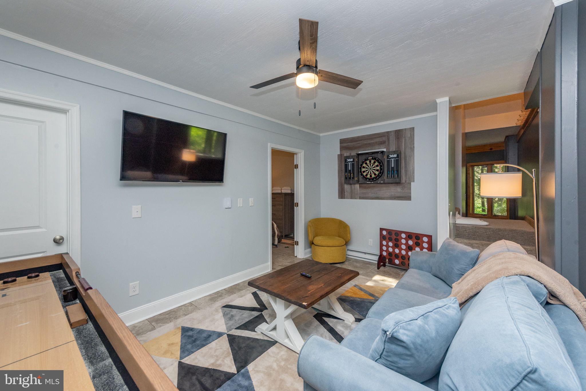 2667 Mayhew Inn Road Oakland, MD 21550 - Photo 20 of 44 a living room with furniture and a flat screen tv