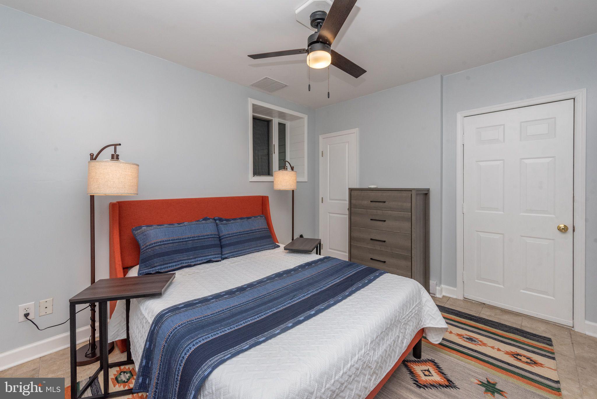 2667 Mayhew Inn Road Oakland, MD 21550 - Photo 23 of 44 a bedroom with a bed and a chandelier