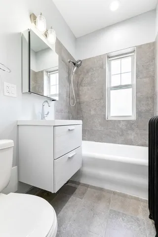 a bathroom with a sink a toilet and bathtub