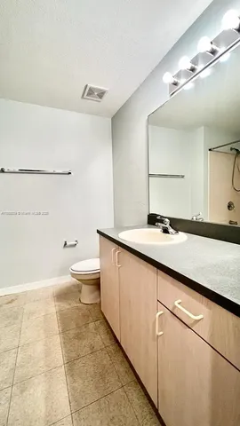 a bathroom with a sink a toilet and a mirror