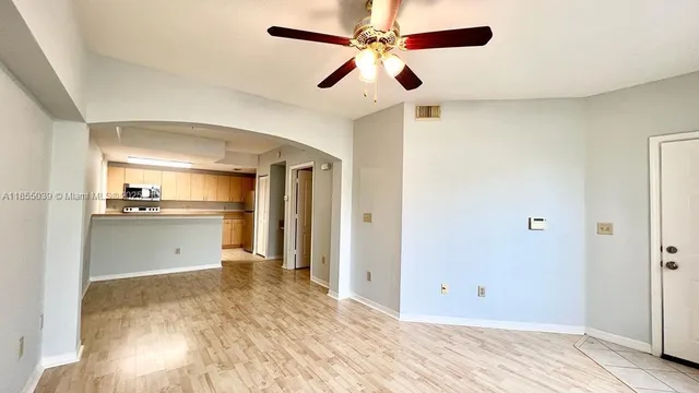 a view of a kitchen with a sink and a refrigerator