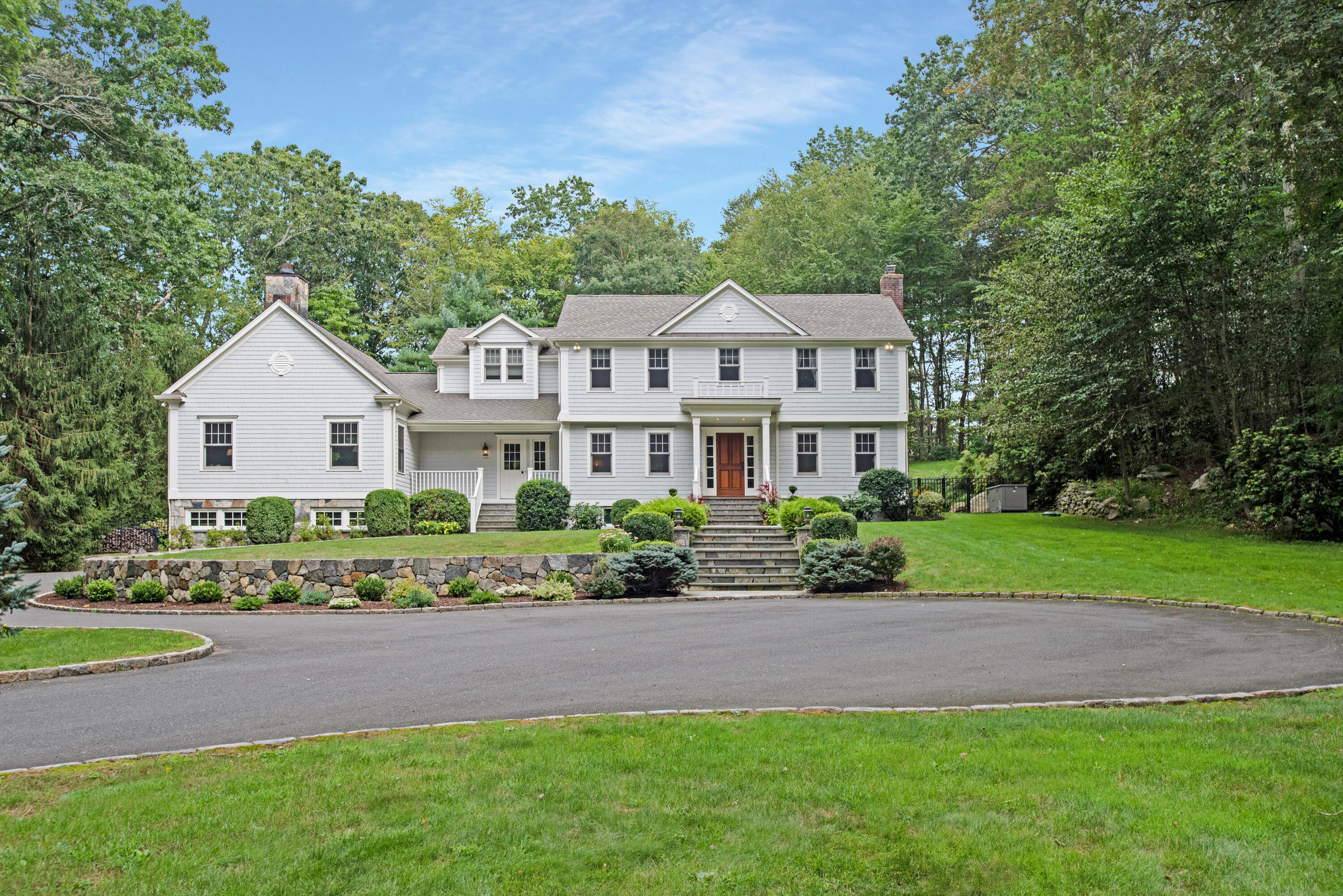 346 Frogtown Road New Canaan, CT 06840 - Photo 1 of 36 a front view of a house with a garden