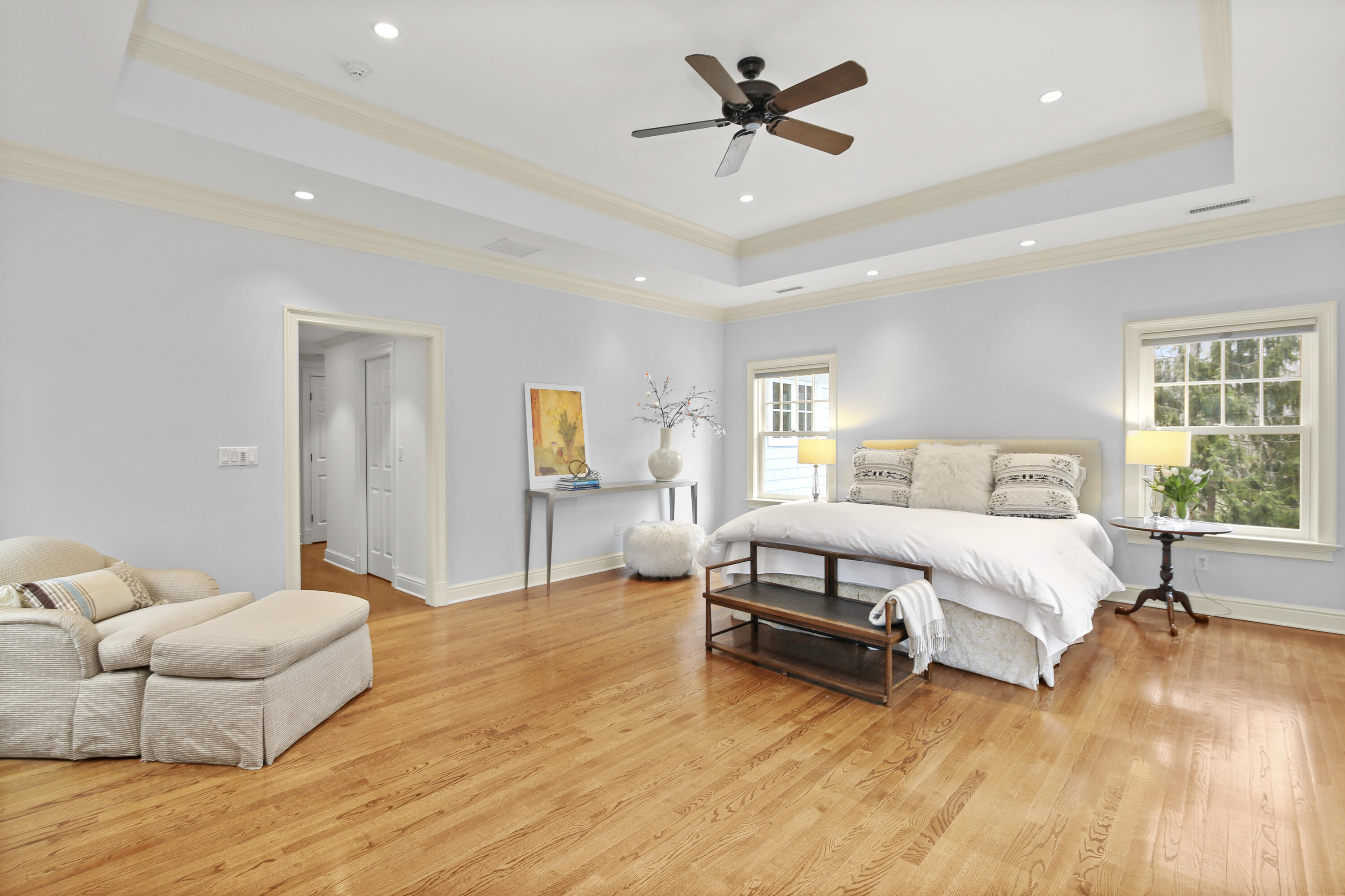 346 Frogtown Road New Canaan, CT 06840 - Photo 19 of 36 a spacious bedroom with a bed a couch and a window