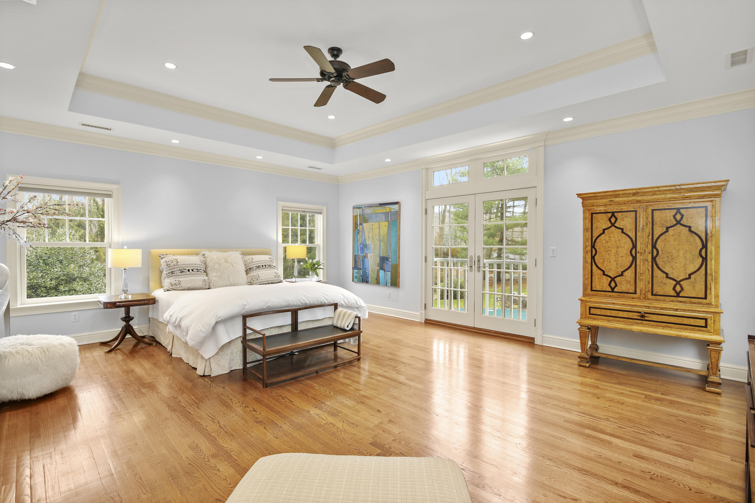 346 Frogtown Road New Canaan, CT 06840 - Photo 20 of 36 a spacious bedroom with a large bed and a chandelier