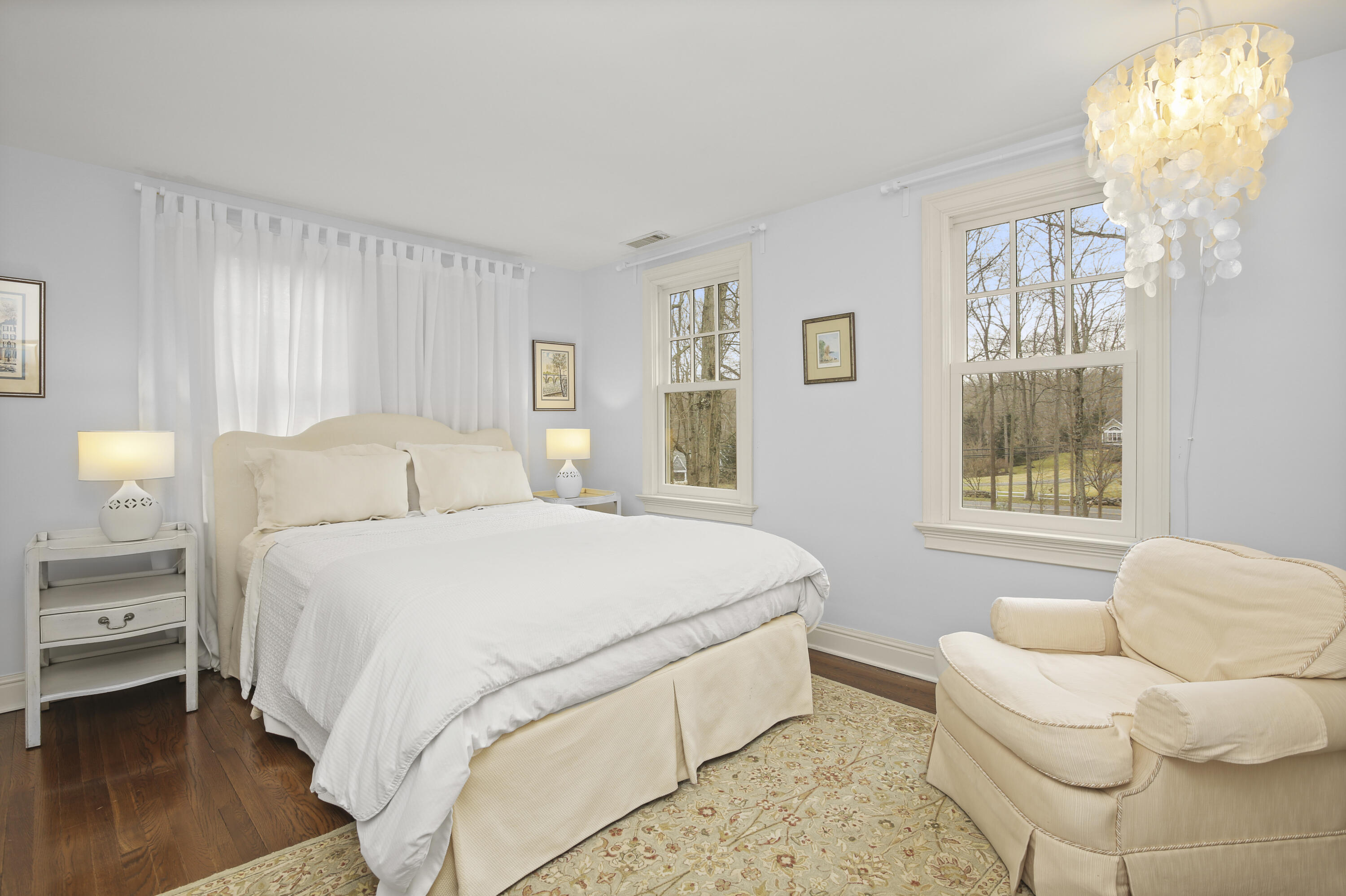 346 Frogtown Road New Canaan, CT 06840 - Photo 25 of 36 a bedroom with a bed and a chandelier