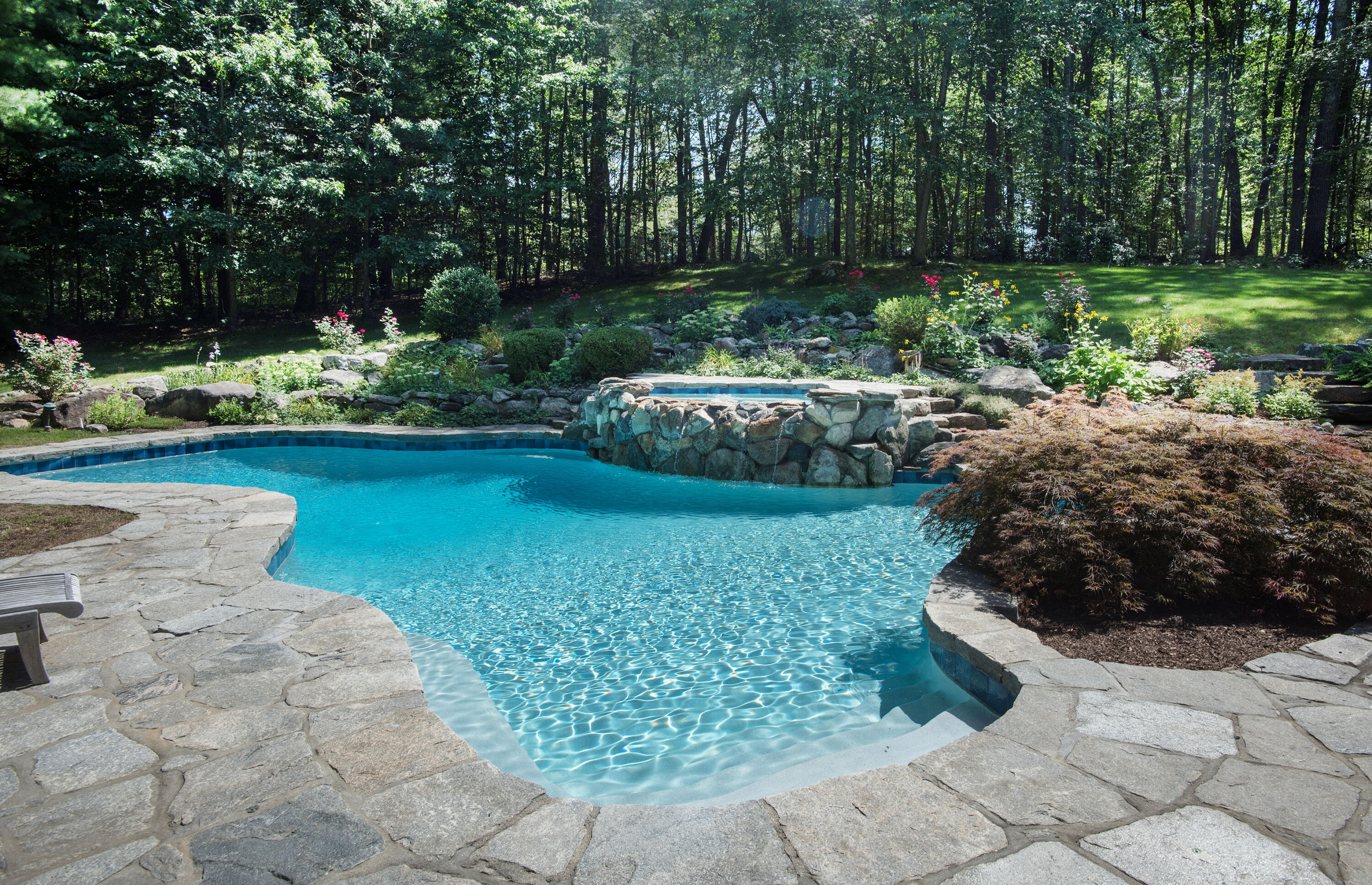 346 Frogtown Road New Canaan, CT 06840 - Photo 3 of 36 a view of a backyard with fountain plants and large tree