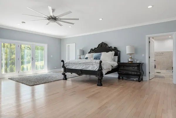 a bedroom with furniture and a wooden floor