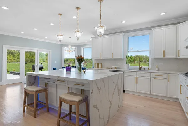 a kitchen with kitchen island granite countertop a sink a center island and cabinets