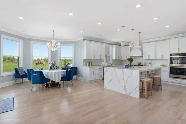 a living room with lots of furniture and kitchen view