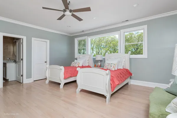 a spacious bedroom with a bed and a window