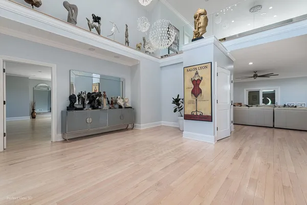 a view of a hallway with wooden floor and furniture