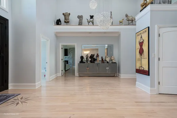 a view of a hallway view with furniture and wooden floor