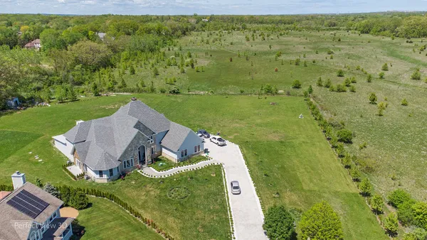 a view of backyard with swimming pool and green space