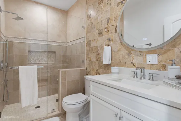 a spacious bedroom with a bed and a chandelier