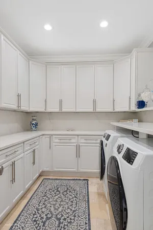 a view of a patio with a table and chairs under an umbrella next to a yard