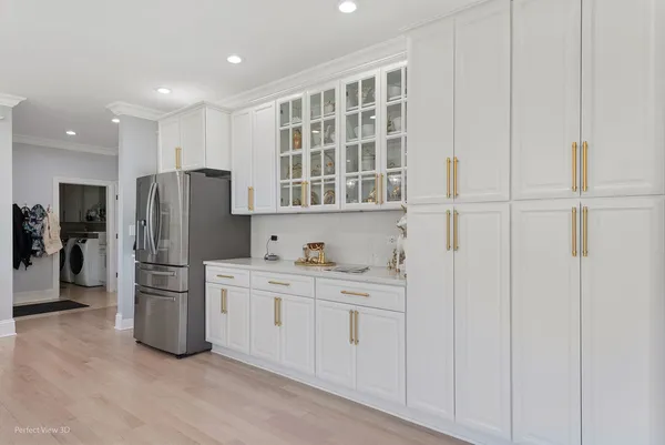 a kitchen with stainless steel appliances a refrigerator and cabinets