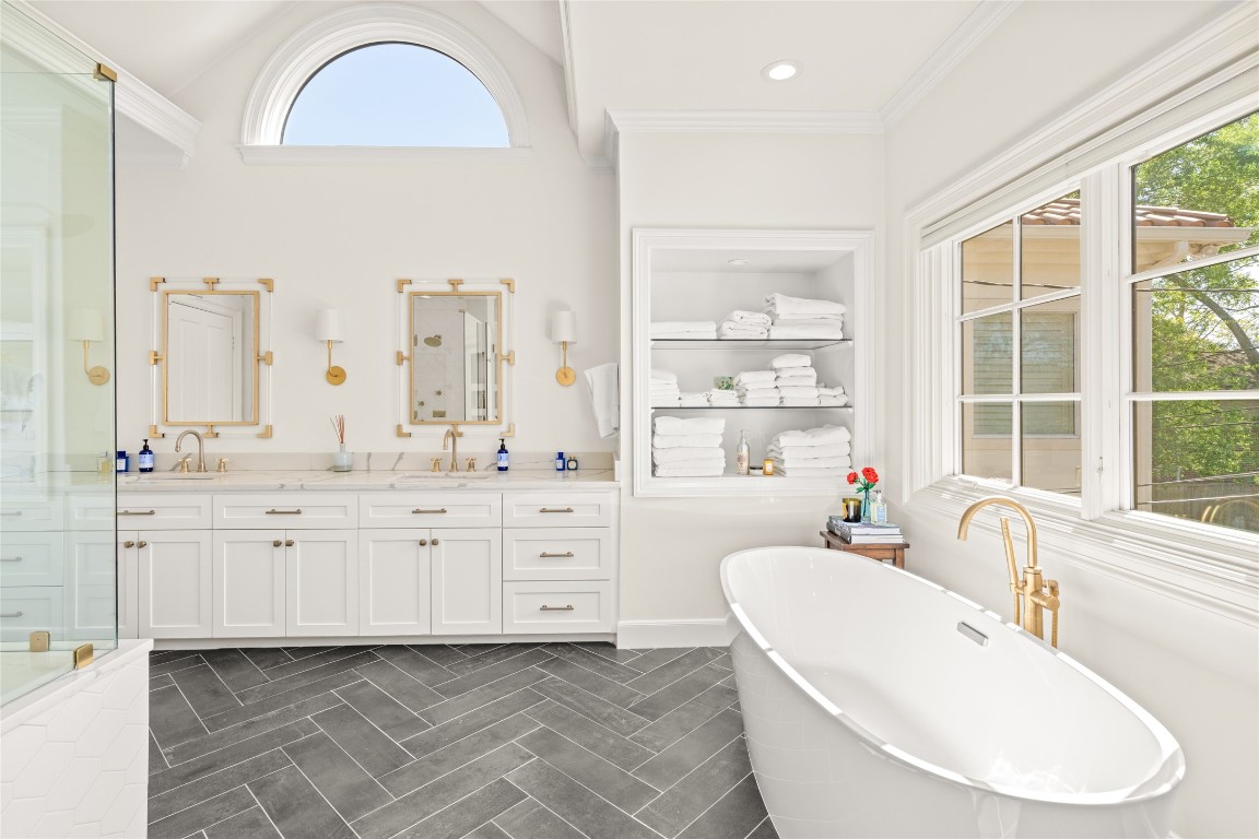 6614 Mercer Street Houston, TX 77005 - Photo 22 of 48 a bathroom with double vanity sinks a mirror and a bathtub