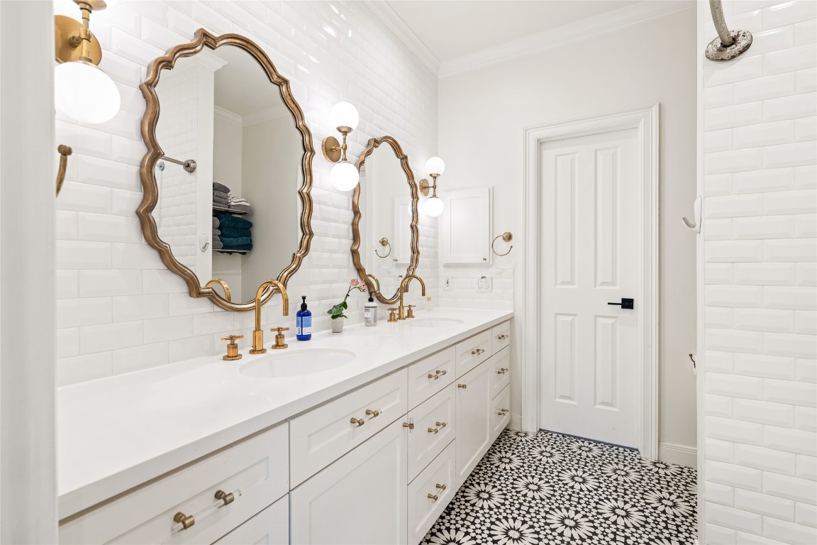 6614 Mercer Street Houston, TX 77005 - Photo 30 of 48 a bathroom with a sink a mirror and a shower