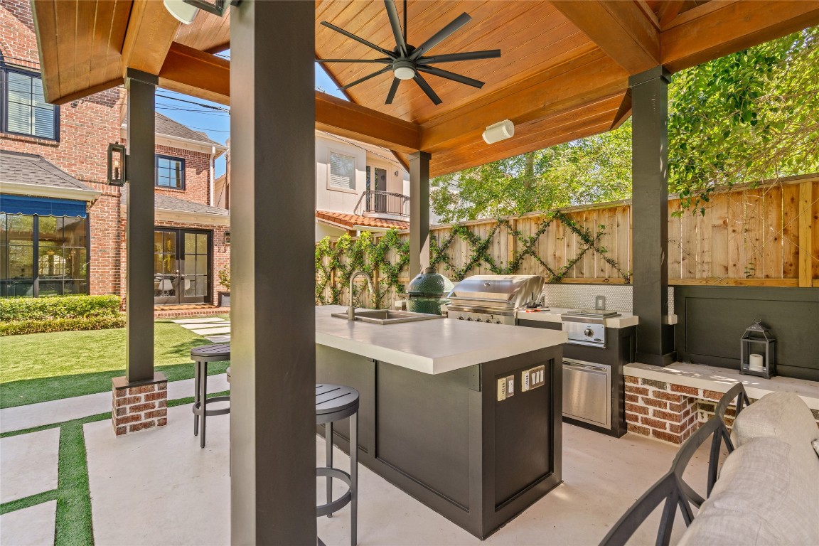 6614 Mercer Street Houston, TX 77005 - Photo 40 of 48 a view of a kitchen with a sink and dishwasher next to a yard