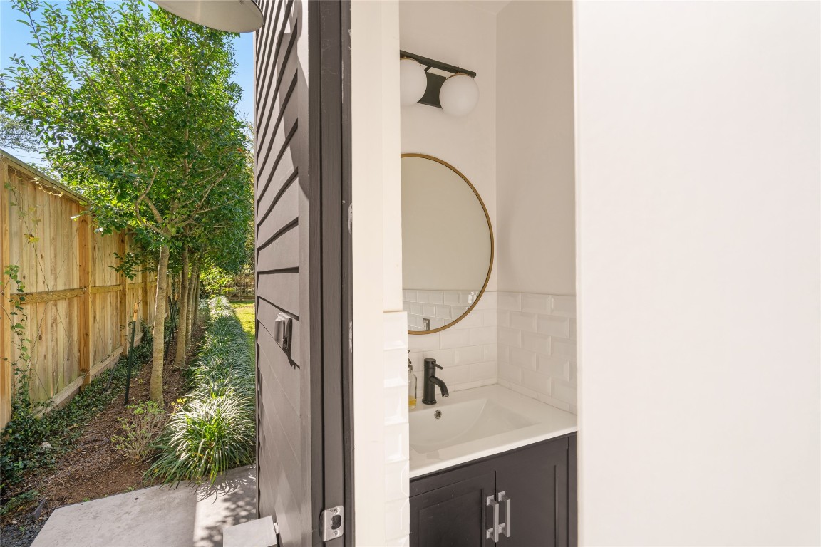 6614 Mercer Street Houston, TX 77005 - Photo 42 of 48 a bathroom with a sink and mirror