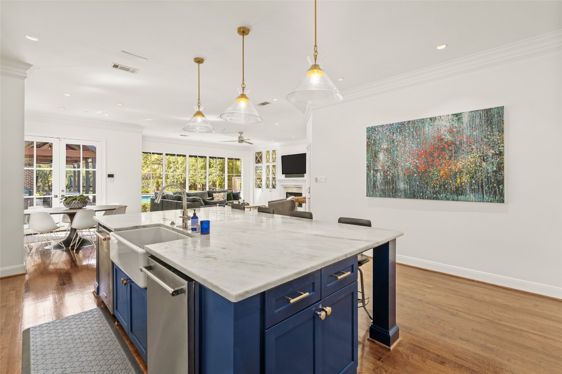 6614 Mercer Street Houston, TX 77005 - Photo 9 of 48 a view of kitchen island a sink wooden floor and living room view