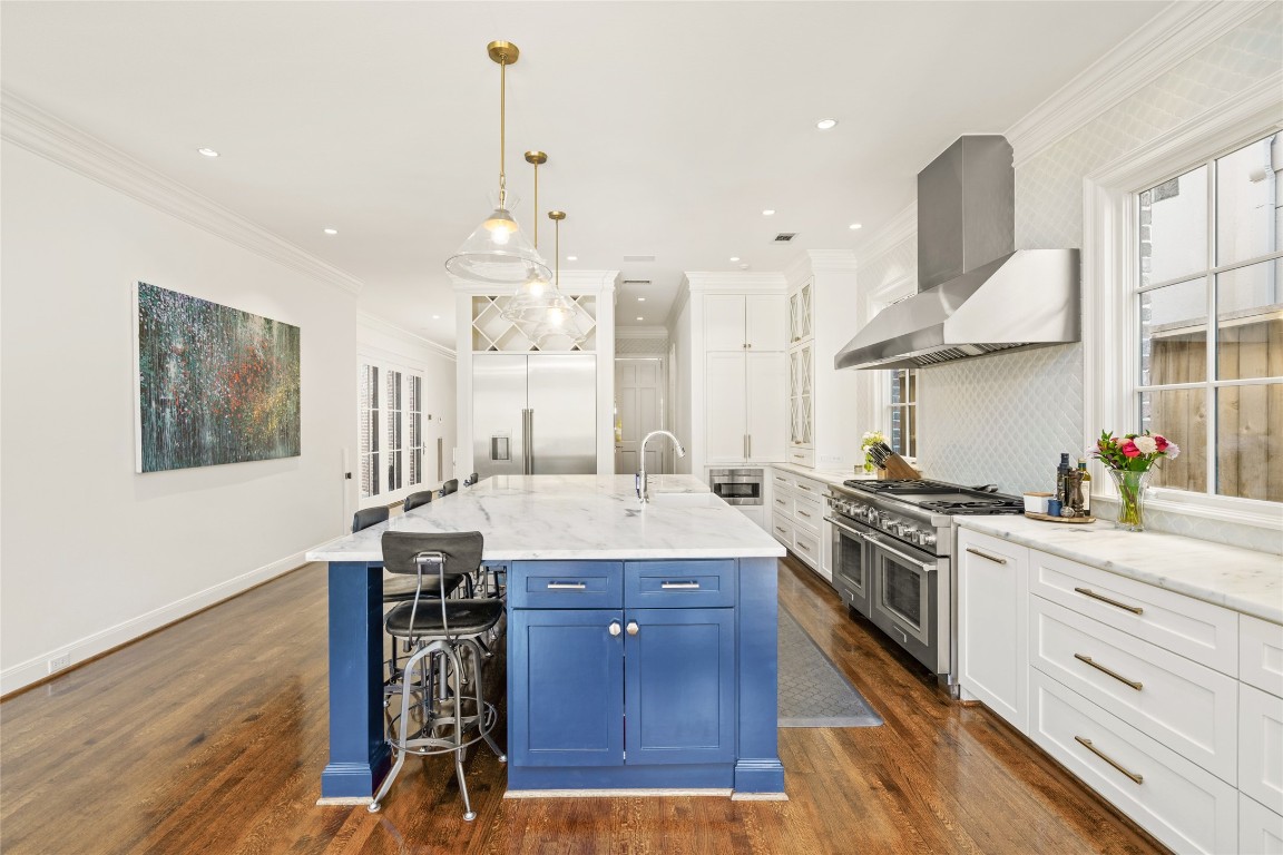 6614 Mercer Street Houston, TX 77005 - Photo 10 of 48 a kitchen with a stove a chandelier and wooden floor