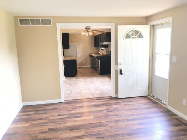 5707 Fox Lake Road McHenry, IL 60051 - Photo 5 of 14 a view of a hallway with wooden floor and a living room