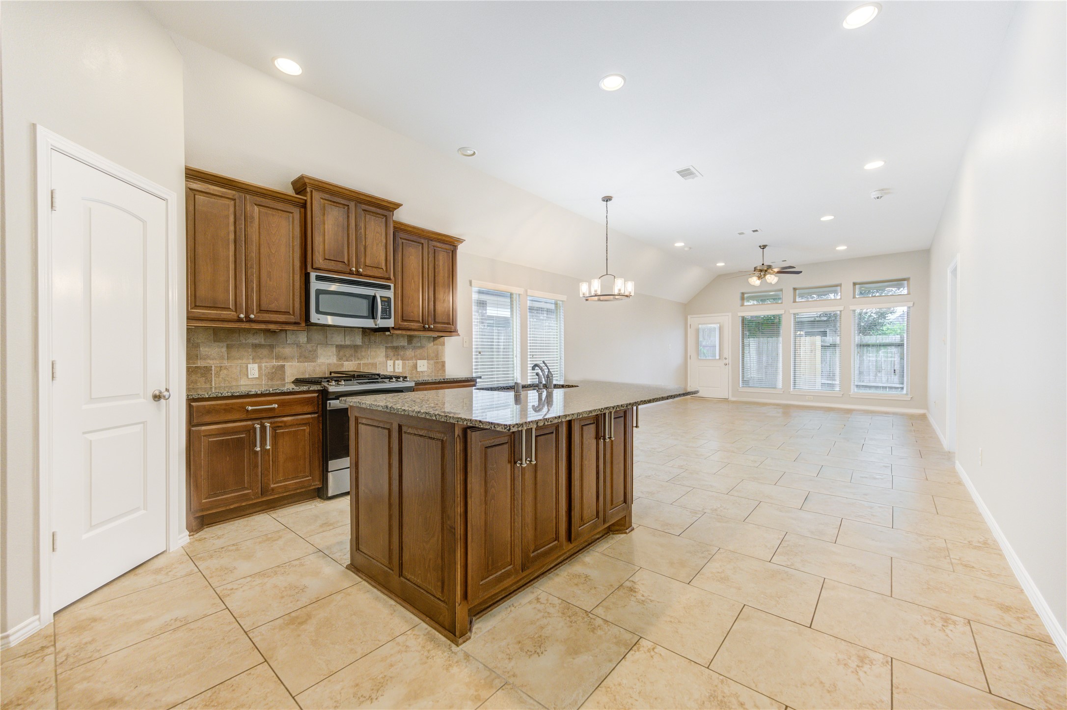 27407 Gatlin Lane Spring, TX 77386 - Photo 13 of 35 Enjoy open sightlines from the kitchen all the way to the living room and backyard beyond. Whether preparing meals or hosting guests, the thoughtful layout keeps everyone connected while filling the home with natural light and a sense of spaciousness.