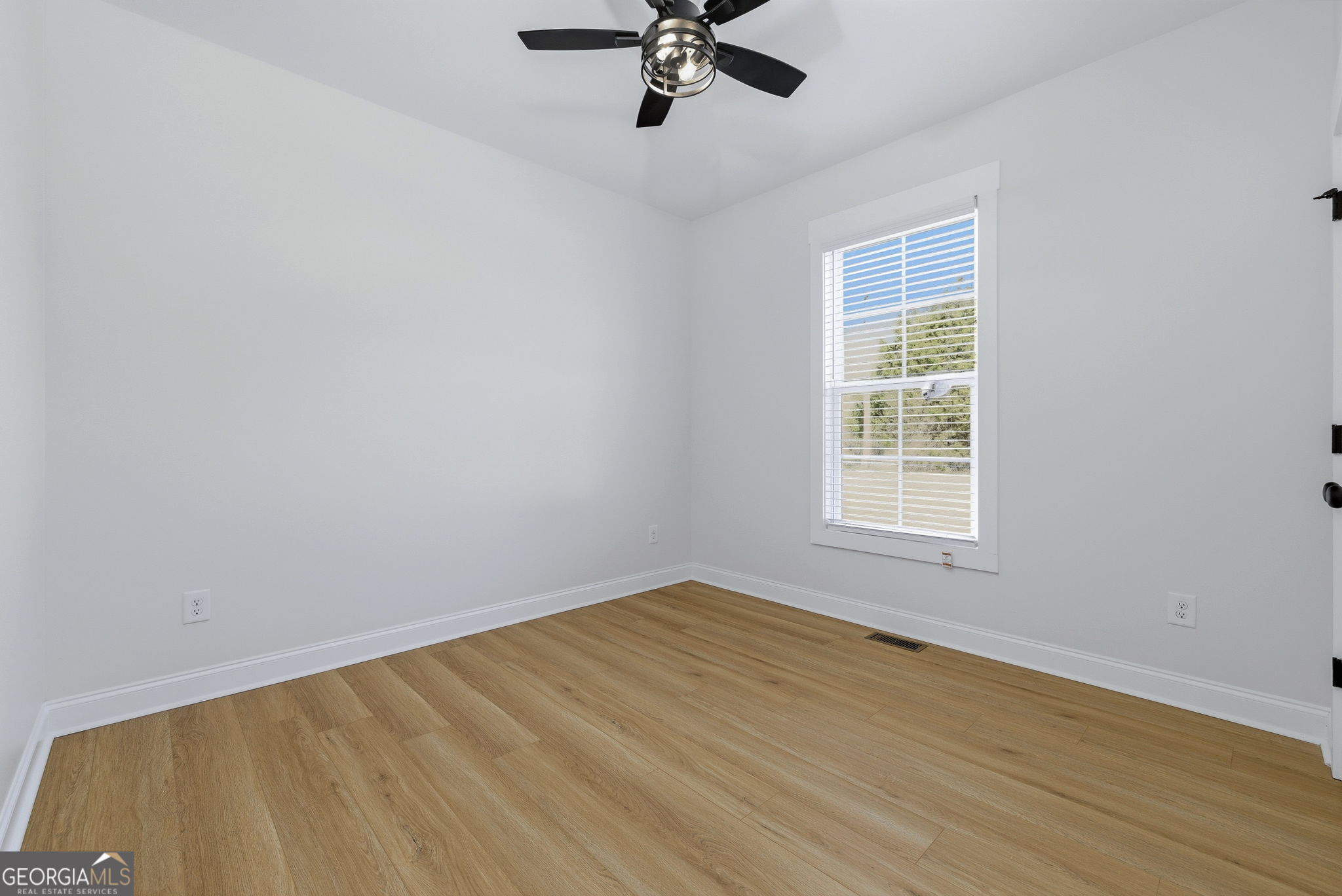 238 Carl Loudermilk Road Mount Airy, GA 30563 - Photo 18 of 28 an empty room with a window and a ceiling fan