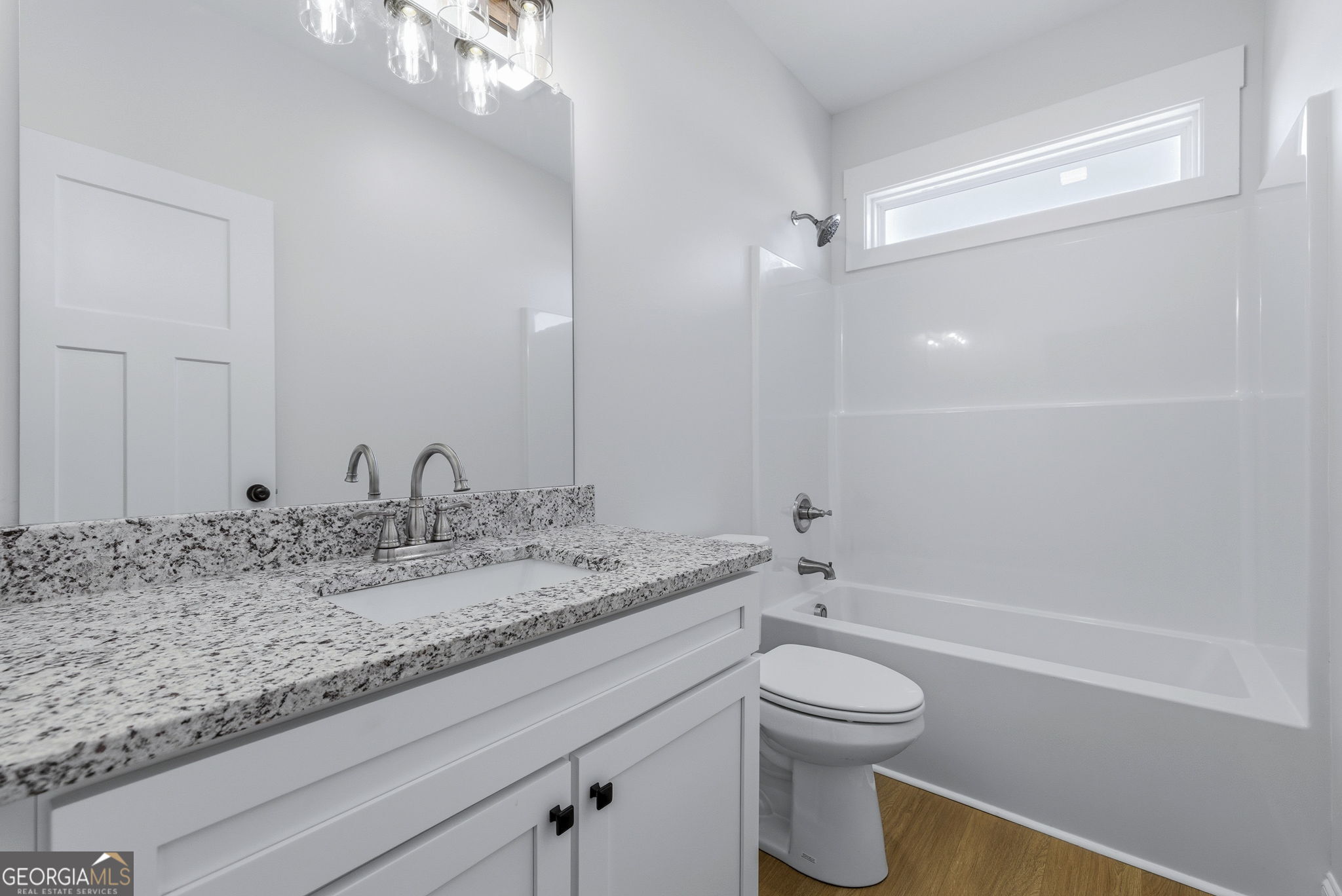 238 Carl Loudermilk Road Mount Airy, GA 30563 - Photo 22 of 28 a bathroom with a granite countertop sink toilet a large mirror and shower