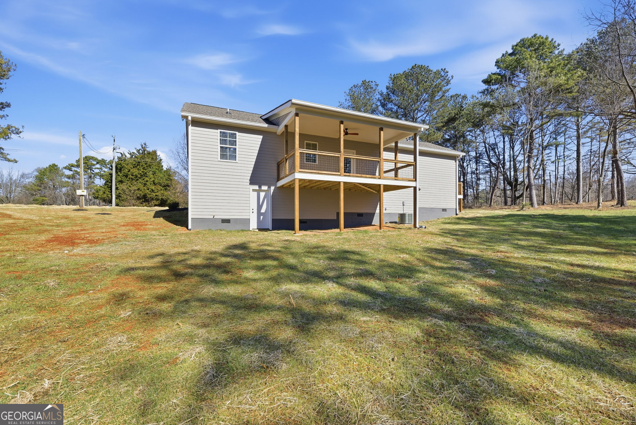238 Carl Loudermilk Road Mount Airy, GA 30563 - Photo 27 of 28 a big room with large windows and a yard