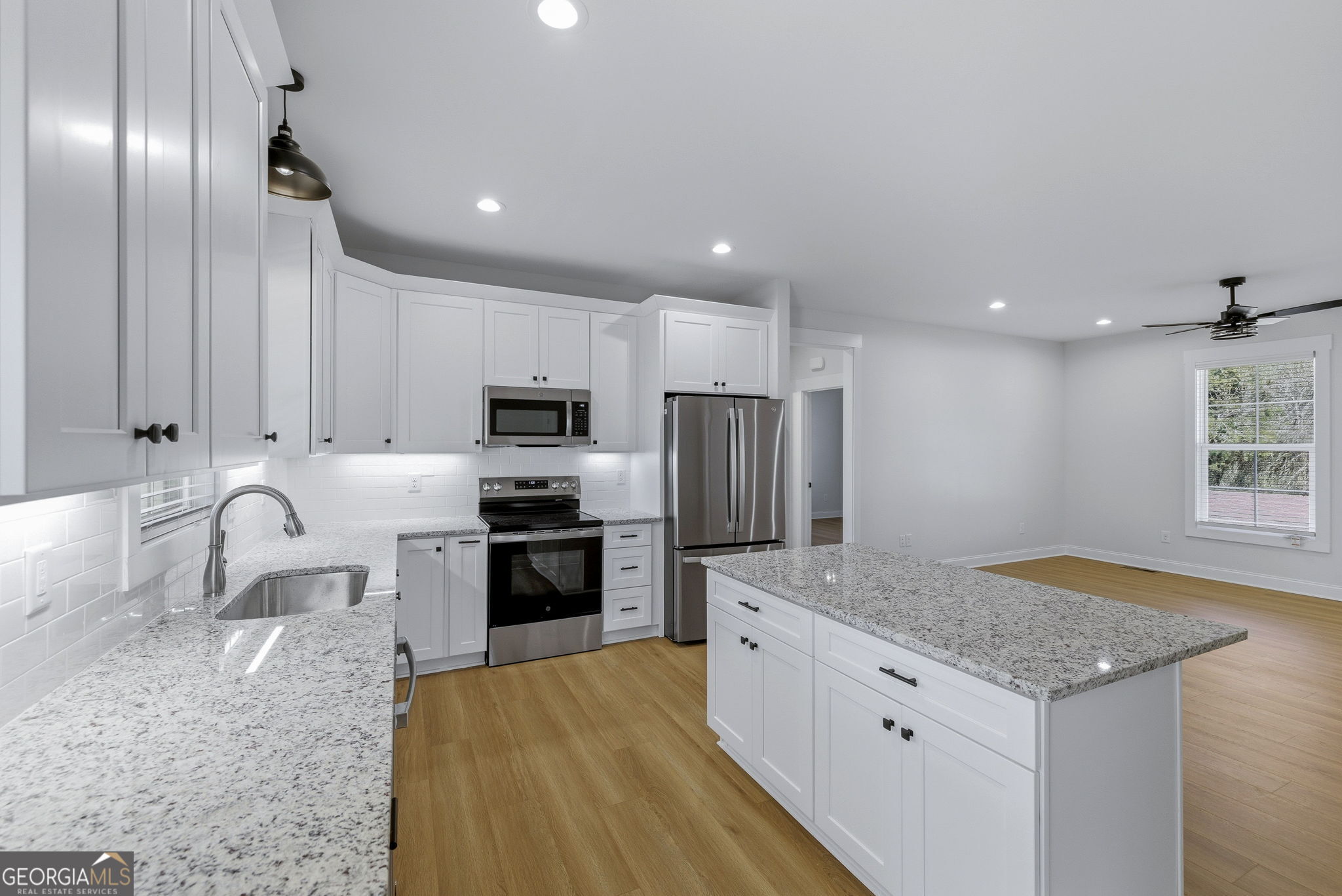 238 Carl Loudermilk Road Mount Airy, GA 30563 - Photo 7 of 28 a kitchen with stainless steel appliances granite countertop a sink stove and refrigerator