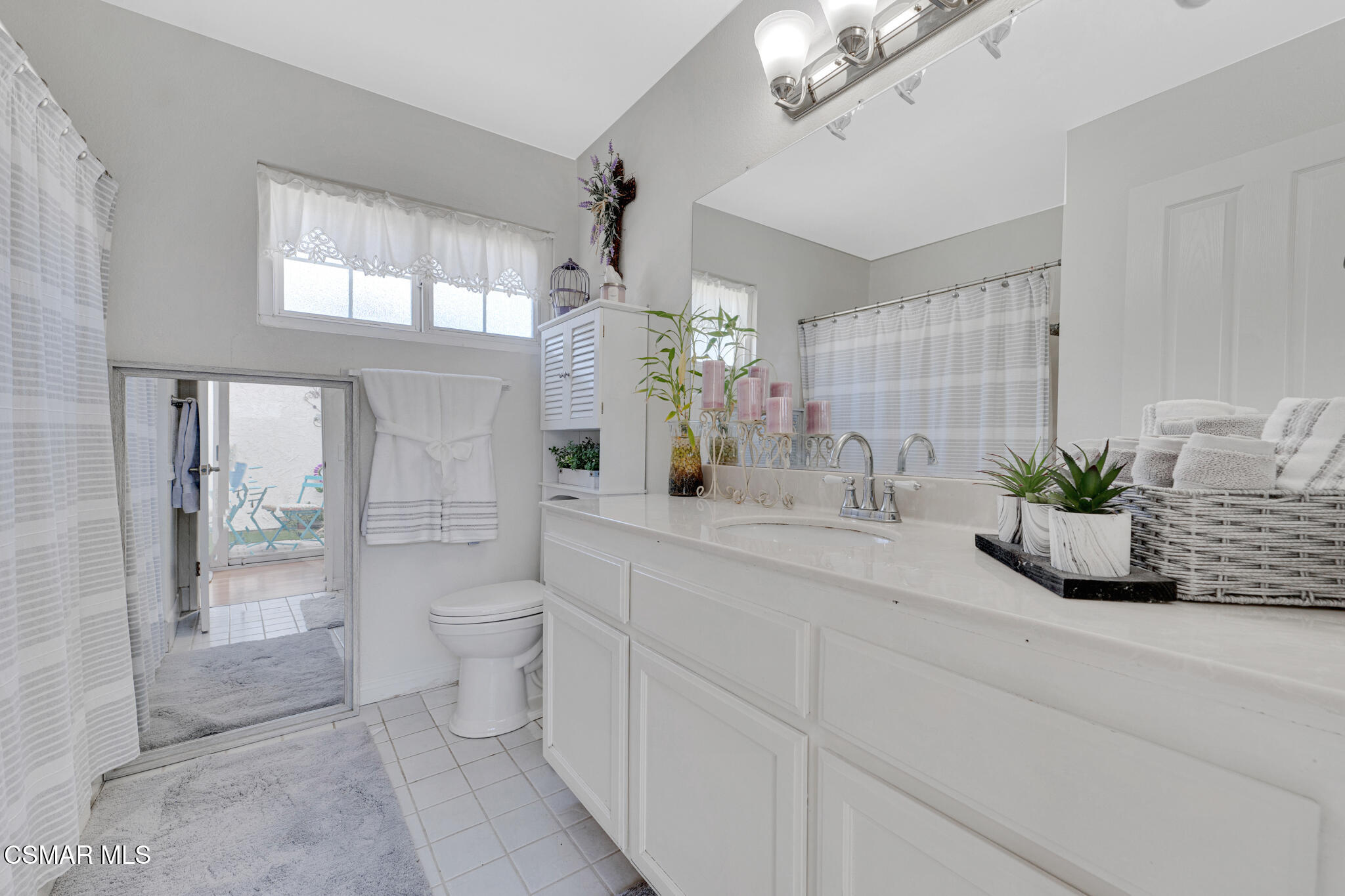 2474 Stow Street Simi Valley, CA 93063 - Photo 12 of 17 a bathroom with a granite countertop sink a toilet and a mirror
