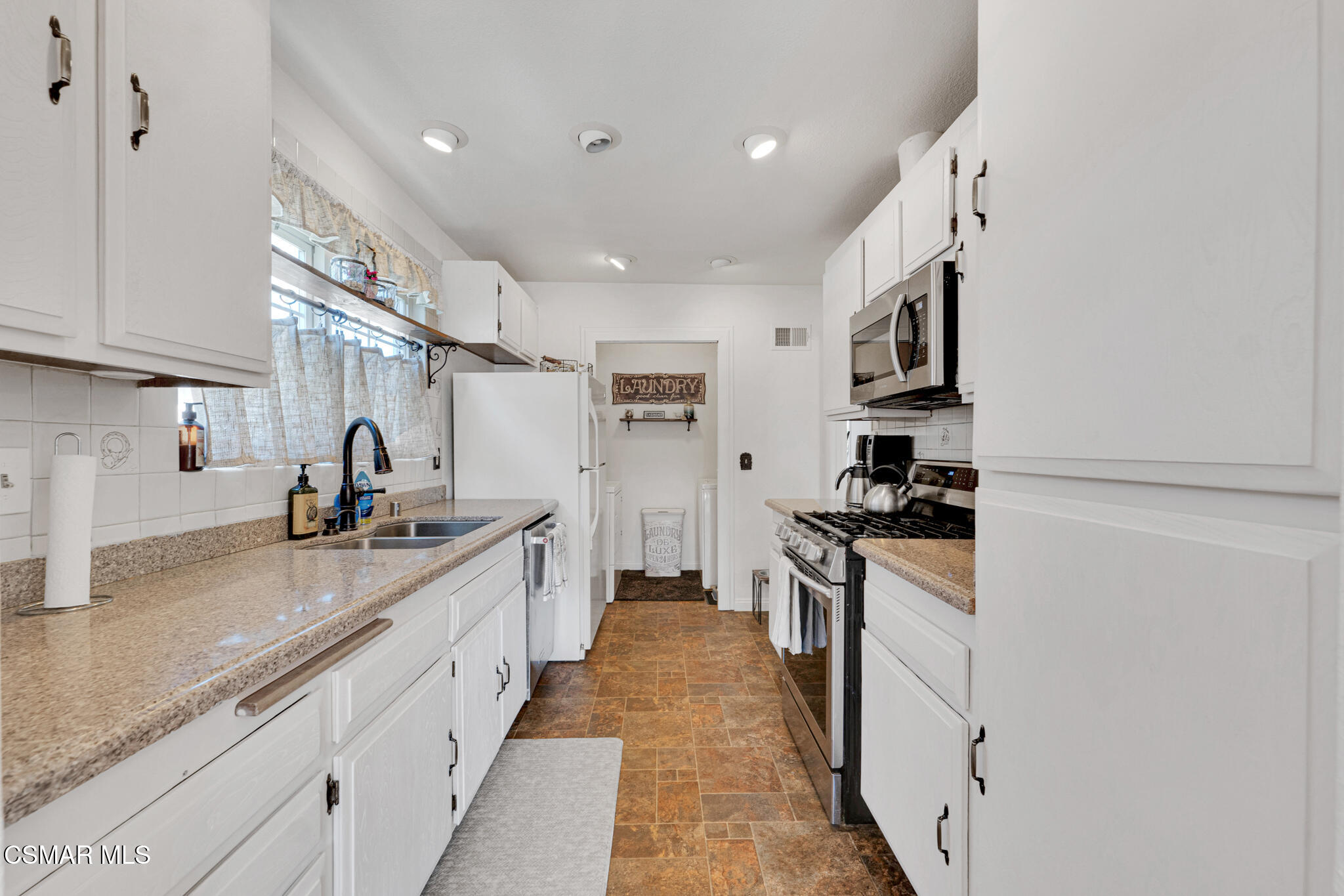 2474 Stow Street Simi Valley, CA 93063 - Photo 9 of 17 a large kitchen with stainless steel appliances lots of counter top space