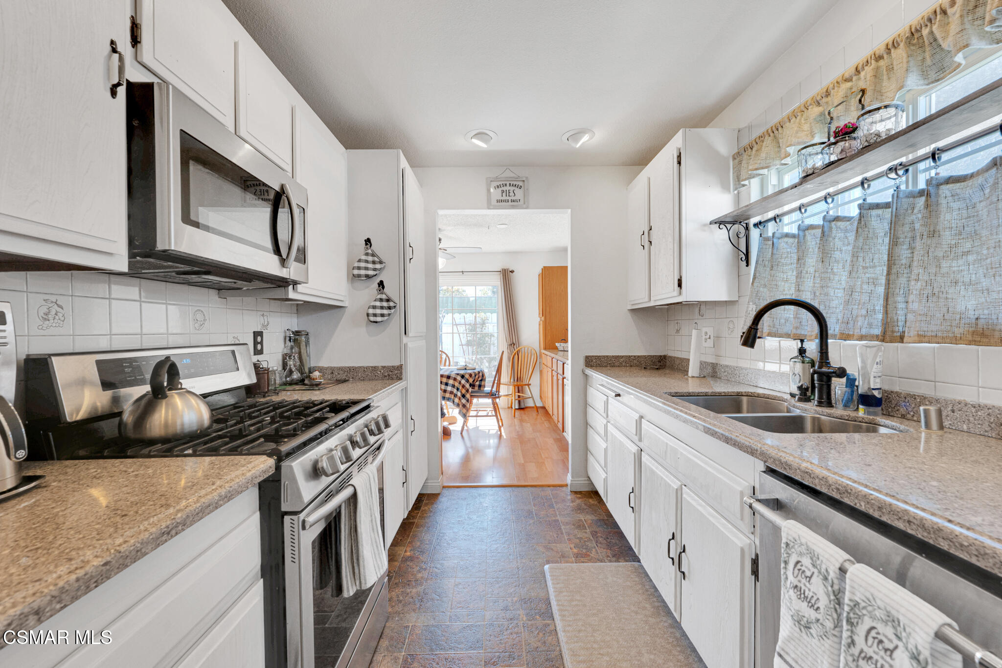 2474 Stow Street Simi Valley, CA 93063 - Photo 10 of 17 a kitchen with stainless steel appliances granite countertop a sink stove and cabinets