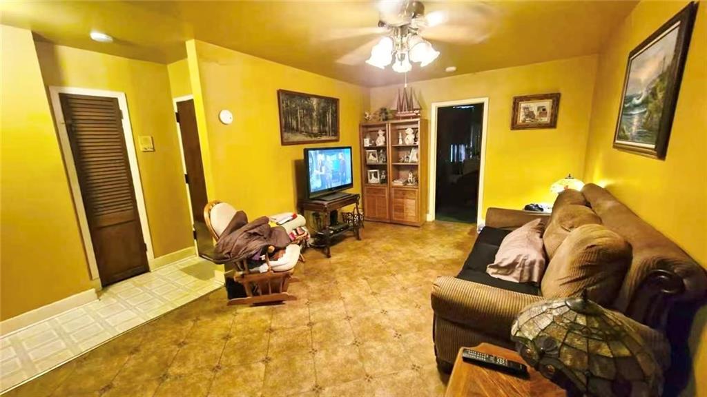 1673 83rd Street Brooklyn, NY 11214 - Photo 11 of 24 a living room with furniture and a flat screen tv