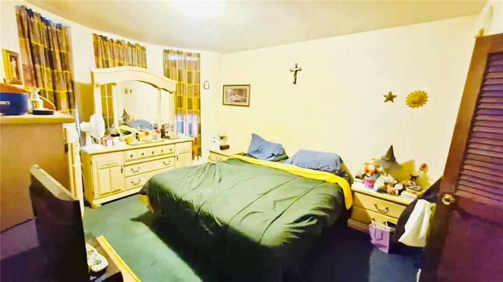 1673 83rd Street Brooklyn, NY 11214 - Photo 12 of 24 a bedroom with a bed and wooden floor