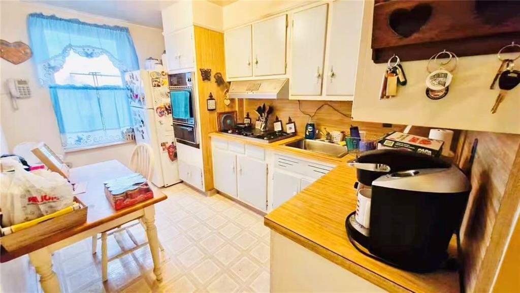 1673 83rd Street Brooklyn, NY 11214 - Photo 13 of 24 a view of a kitchen with sink and cabinets