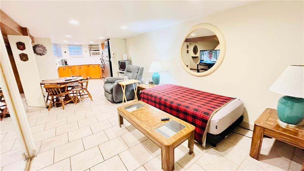 1673 83rd Street Brooklyn, NY 11214 - Photo 17 of 24 a bedroom with a bed a mirror on dresser and a mirror