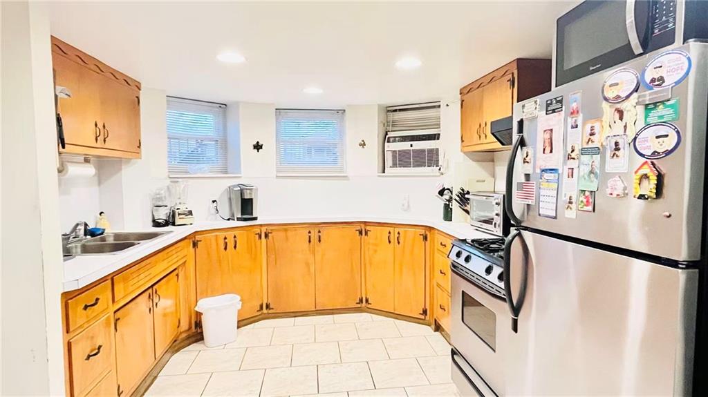 1673 83rd Street Brooklyn, NY 11214 - Photo 19 of 24 a view of a kitchen with a sink and dishwasher with a dining table