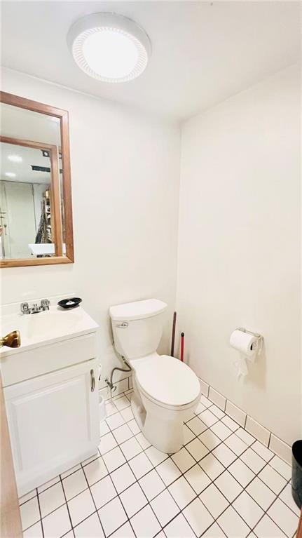 1673 83rd Street Brooklyn, NY 11214 - Photo 23 of 24 a bathroom with a toilet a sink and a mirror