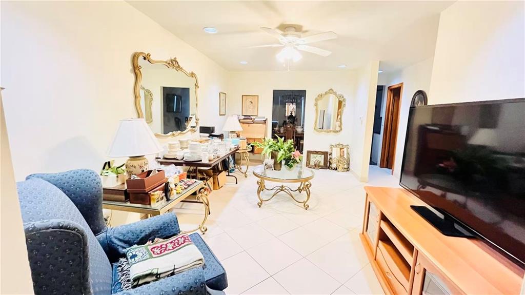 1673 83rd Street Brooklyn, NY 11214 - Photo 4 of 24 a living room with furniture a flat screen tv and kitchen view