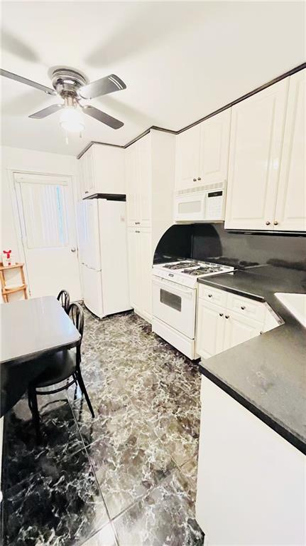 1673 83rd Street Brooklyn, NY 11214 - Photo 8 of 24 a kitchen with a sink a stove and white cabinets
