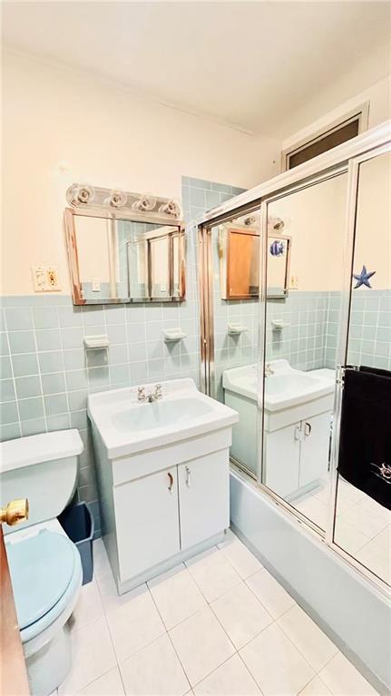 1673 83rd Street Brooklyn, NY 11214 - Photo 9 of 24 a bathroom with a sink a toilet and tub