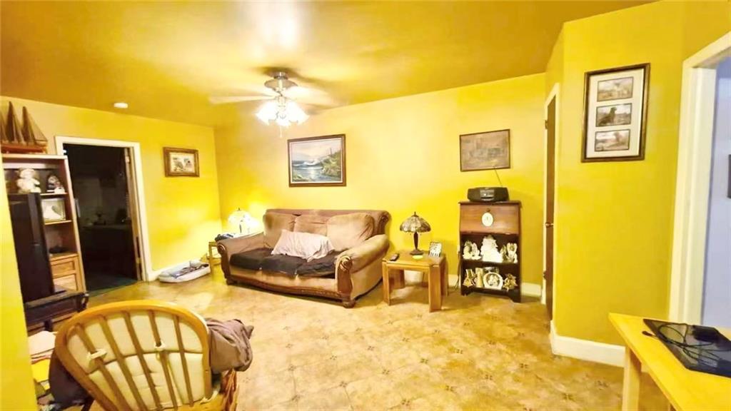 1673 83rd Street Brooklyn, NY 11214 - Photo 10 of 24 a living room with furniture and a flat screen tv