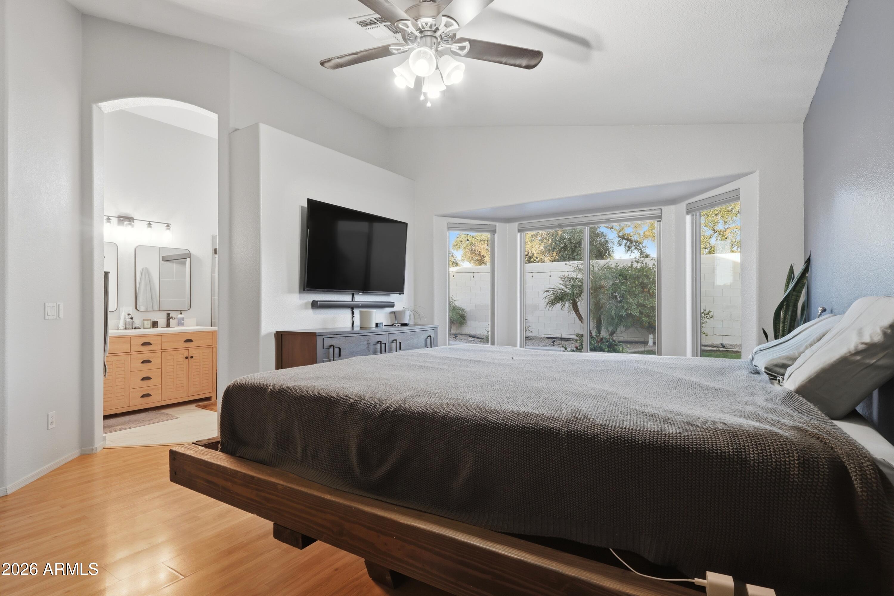 661 North Joshua Tree Lane Gilbert, AZ 85234 - Photo 14 of 47 a bedroom with a bed and glass door