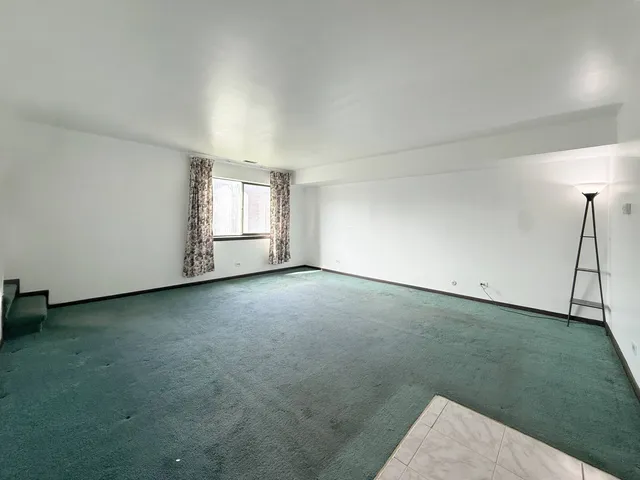 an empty room with an empty space and a window