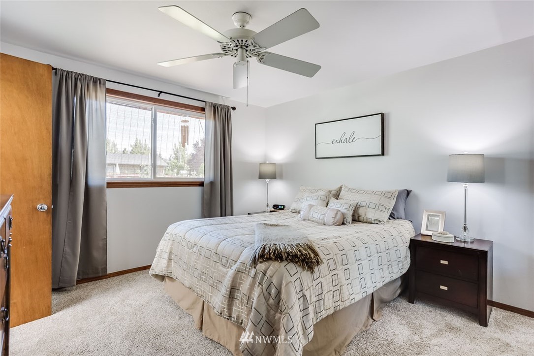 5209 Northeast 3rd Street Renton, WA 98059 - Photo 12 of 31 a bedroom with a large bed and a window
